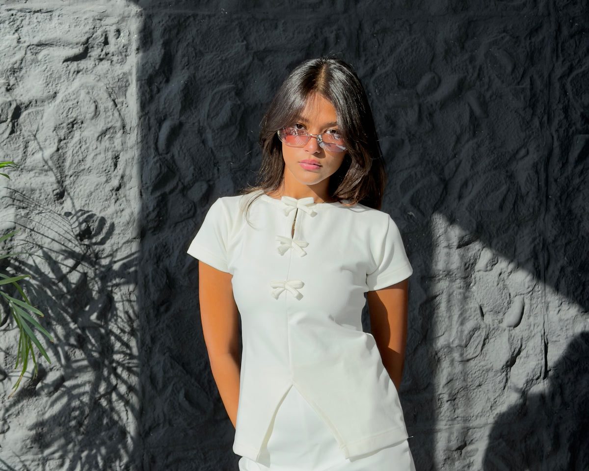 Model wearing The Bow Top in White from the LAM Studios Studio Contrast edit